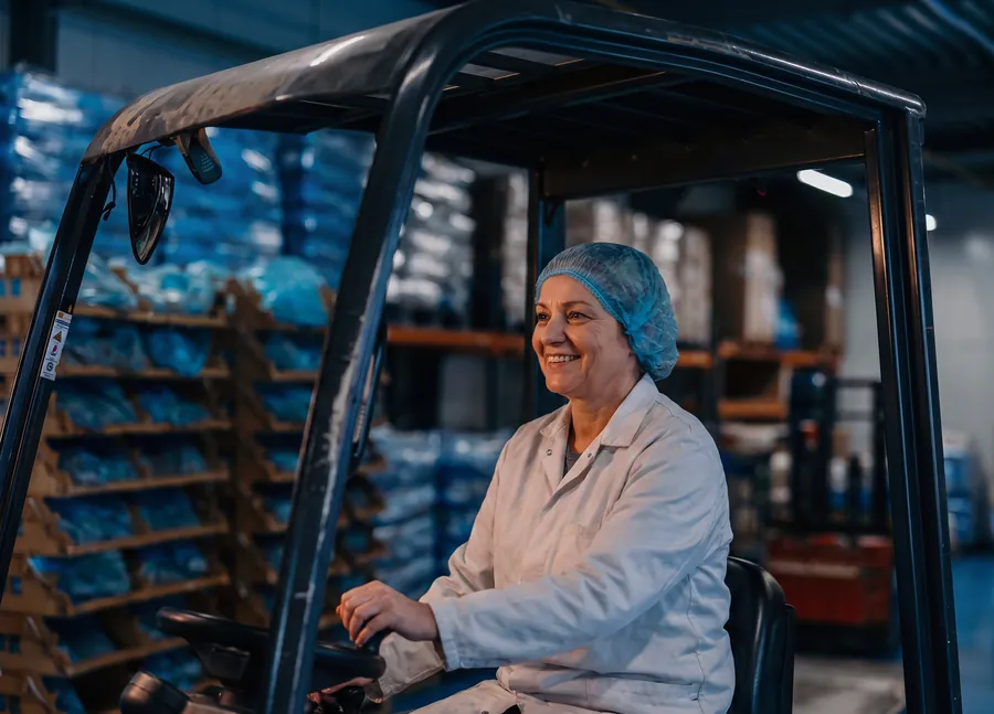A forklift operator moving stock through the warehouse